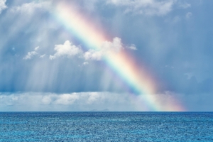 Rainbow over the ocean representing hope and increased access to therapy services, fees, and insurance options.