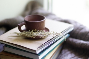 Cup and journal representing therapy services, fees, and insurance information